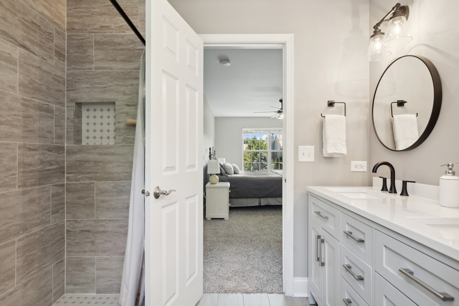 2415 Fen View Circle Island Lake, IL 60042 - Photo 14 of 27 a bathroom with a sink a mirror and a shower