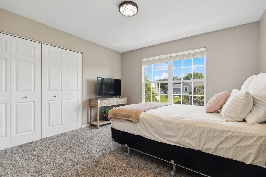 2415 Fen View Circle Island Lake, IL 60042 - Photo 15 of 27 a bedroom with a bed and a television