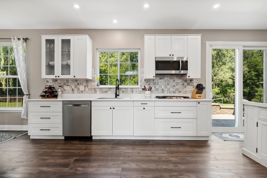 2415 Fen View Circle Island Lake, IL 60042 - Photo 6 of 27 a kitchen with granite countertop white cabinets and window
