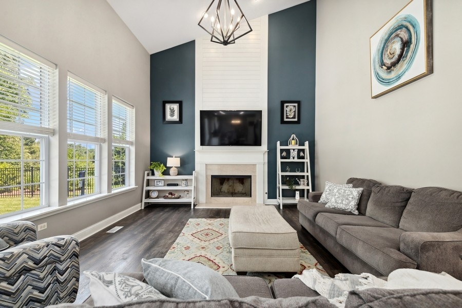 2415 Fen View Circle Island Lake, IL 60042 - Photo 7 of 27 a living room with furniture a large window and a fireplace
