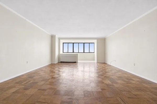 an empty room with windows and mirror