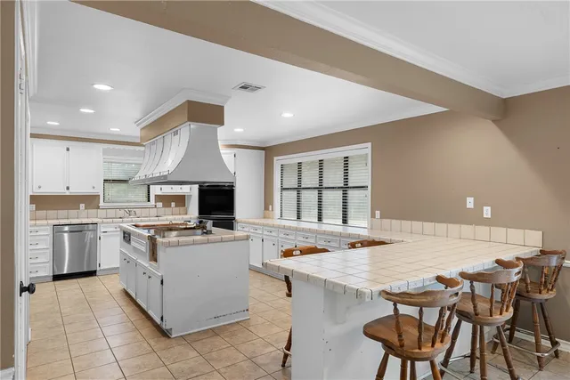 a open kitchen with a stove a sink dishwasher and a refrigerator