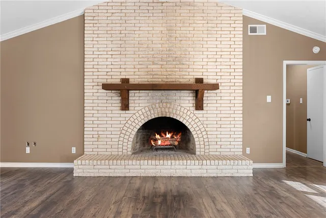 a living room with a fireplace and a wooden floor