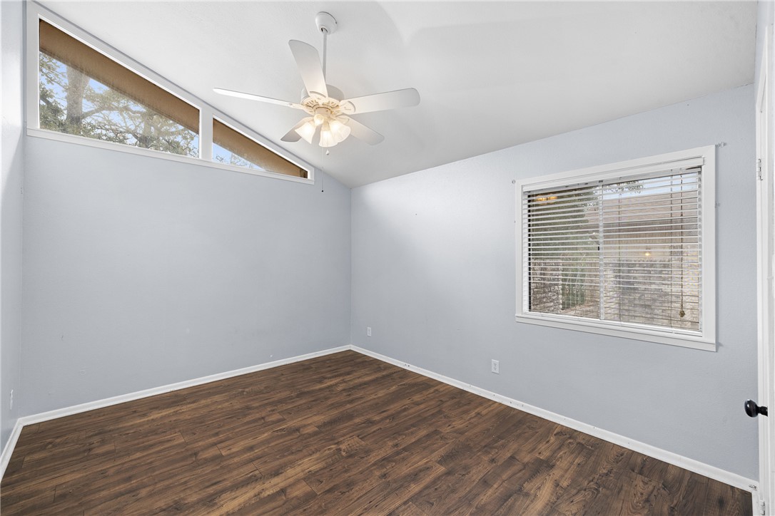 1027 Shadylane Drive Lexington, TX 78947 - Photo 20 of 45 a view of an empty room with wooden floor and a window