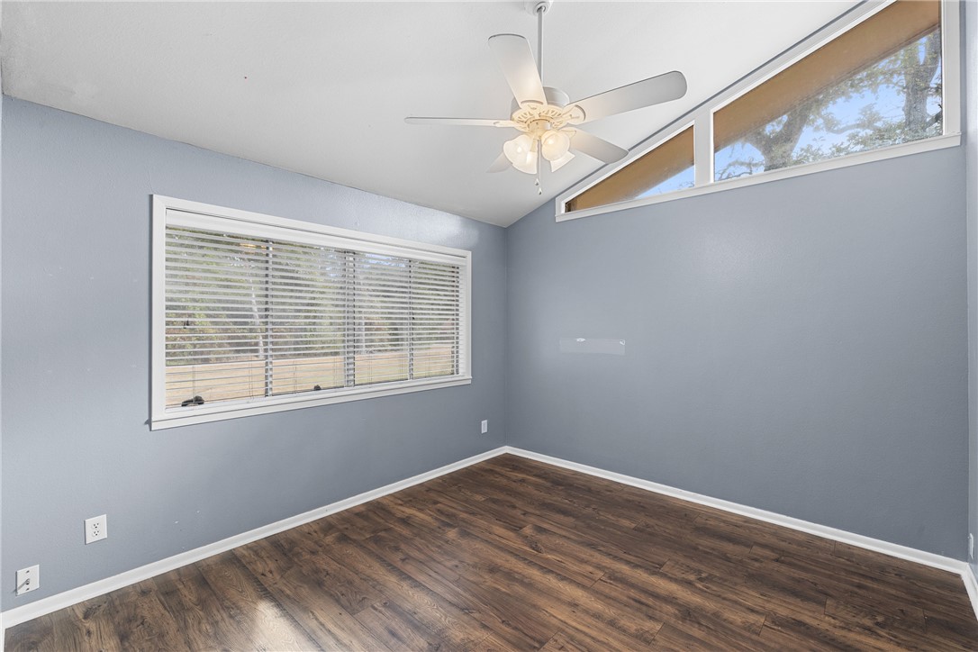 1027 Shadylane Drive Lexington, TX 78947 - Photo 21 of 45 a view of an empty room with wooden floor and a window