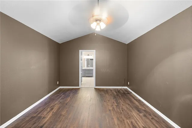 a view of a room with wooden floor and window