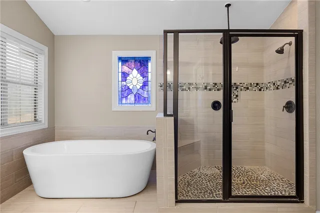 a bathroom with a bathtub and shower