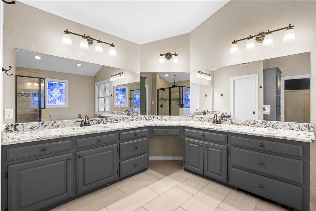 1027 Shadylane Drive Lexington, TX 78947 - Photo 29 of 45 a bathroom with a granite countertop sink double and mirror
