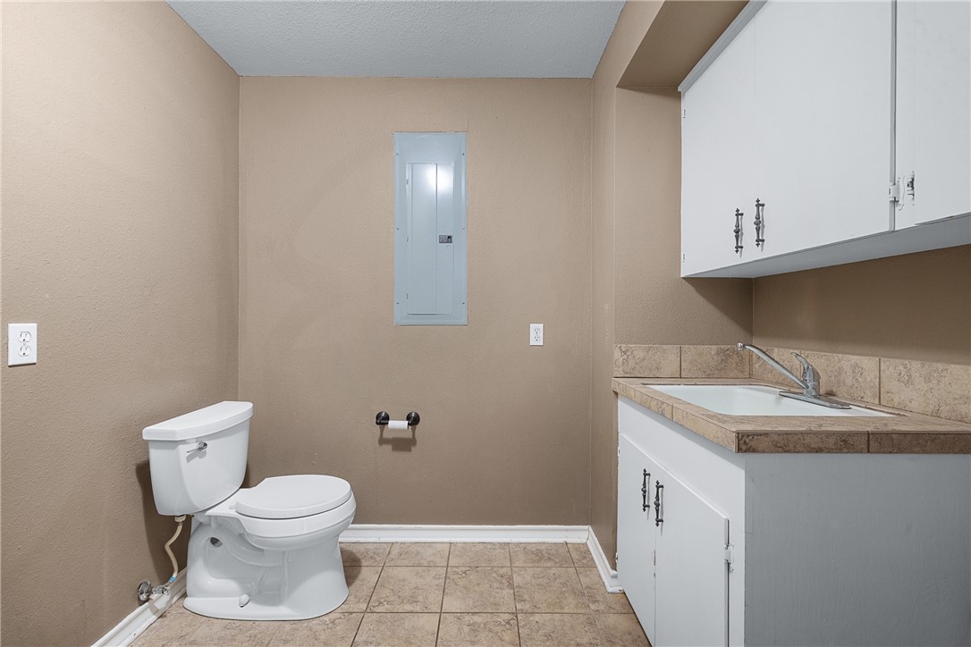 1027 Shadylane Drive Lexington, TX 78947 - Photo 30 of 45 a bathroom with a granite countertop toilet and sink