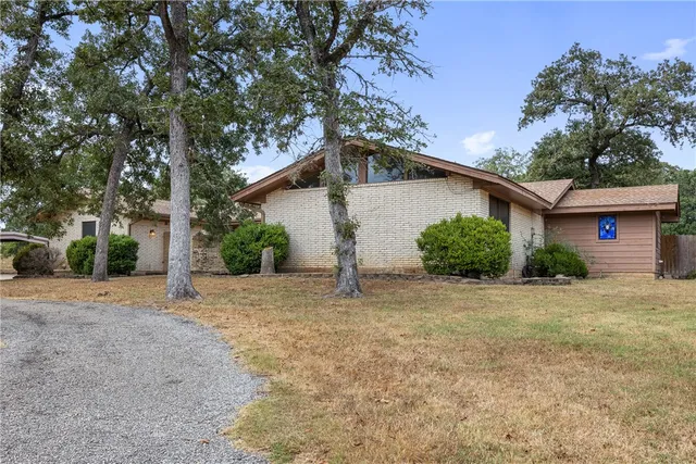 a view of a house with a yard and garage