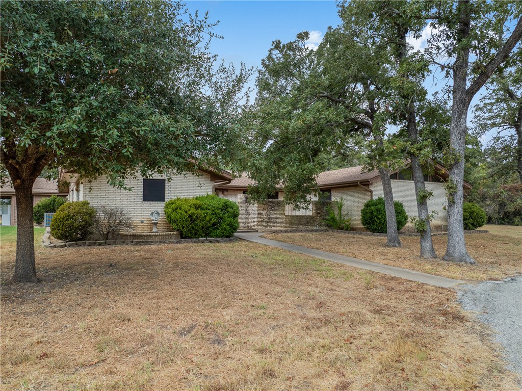 1027 Shadylane Drive Lexington, TX 78947 - Photo 41 of 45 a front view of a house with a yard and a garage