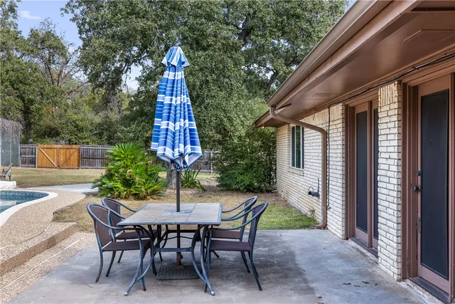 a view of a table and chairs in patio of the house