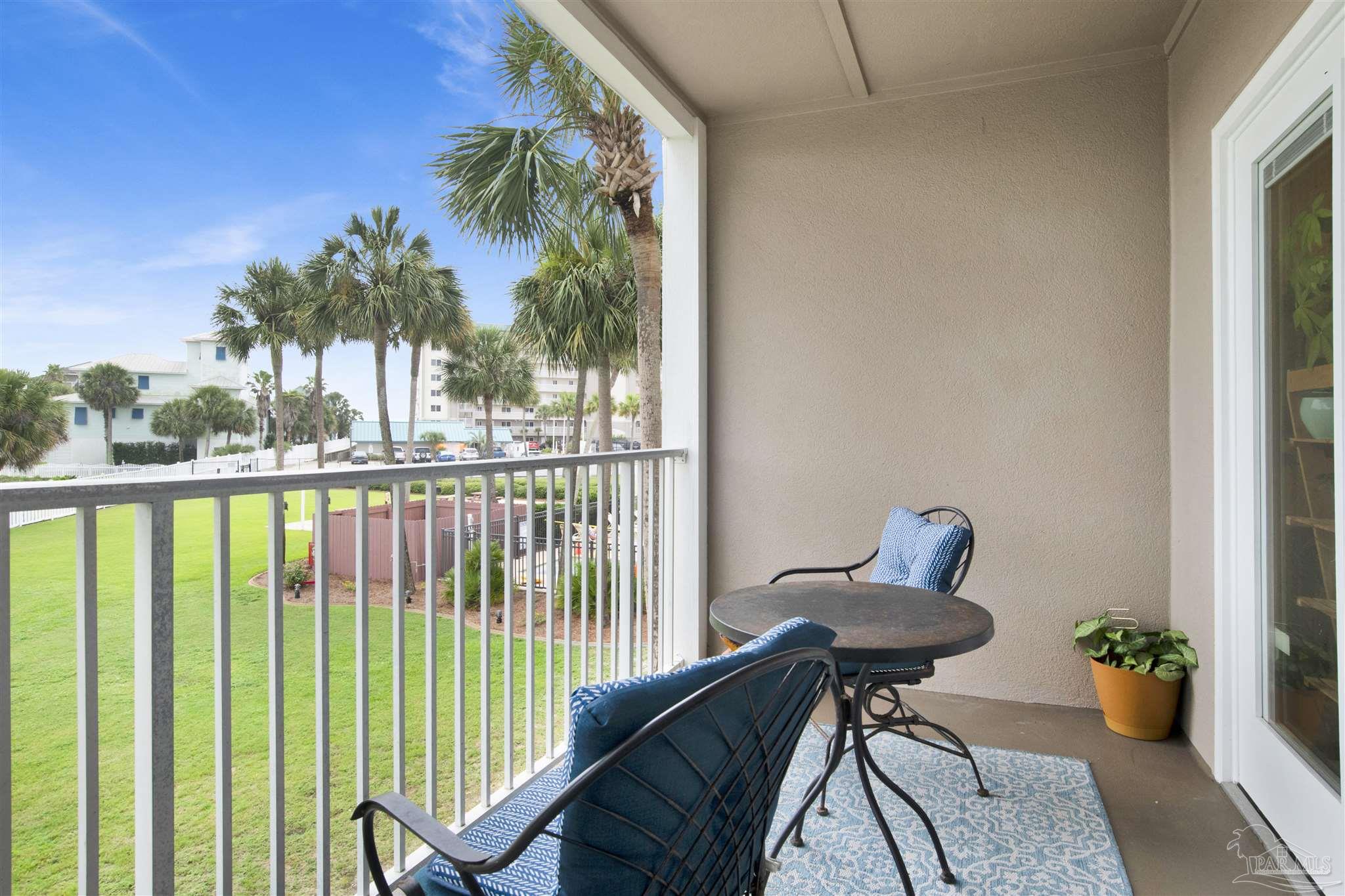 13351 Johnson Beach Road, Unit 203E Perdido Key, FL 32507 - Photo 28 of 55 a view of a balcony with chairs and a potted plant