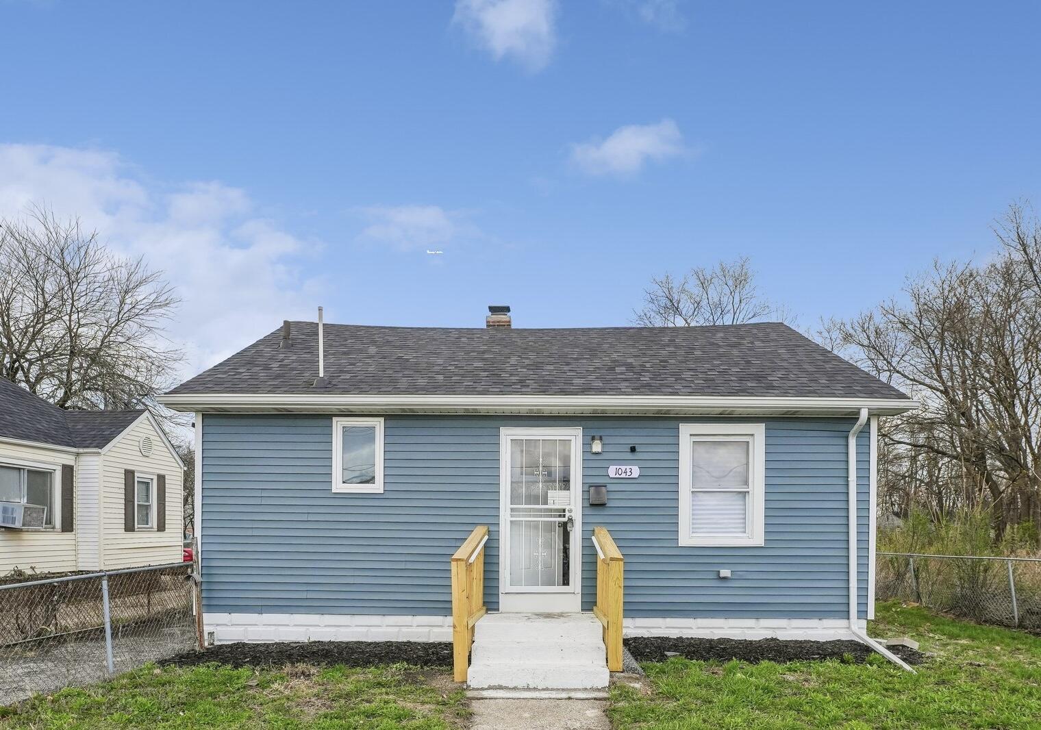 1043 Colfax Street Gary, IN 46406 - Photo 1 of 15 a front view of a house with a garden