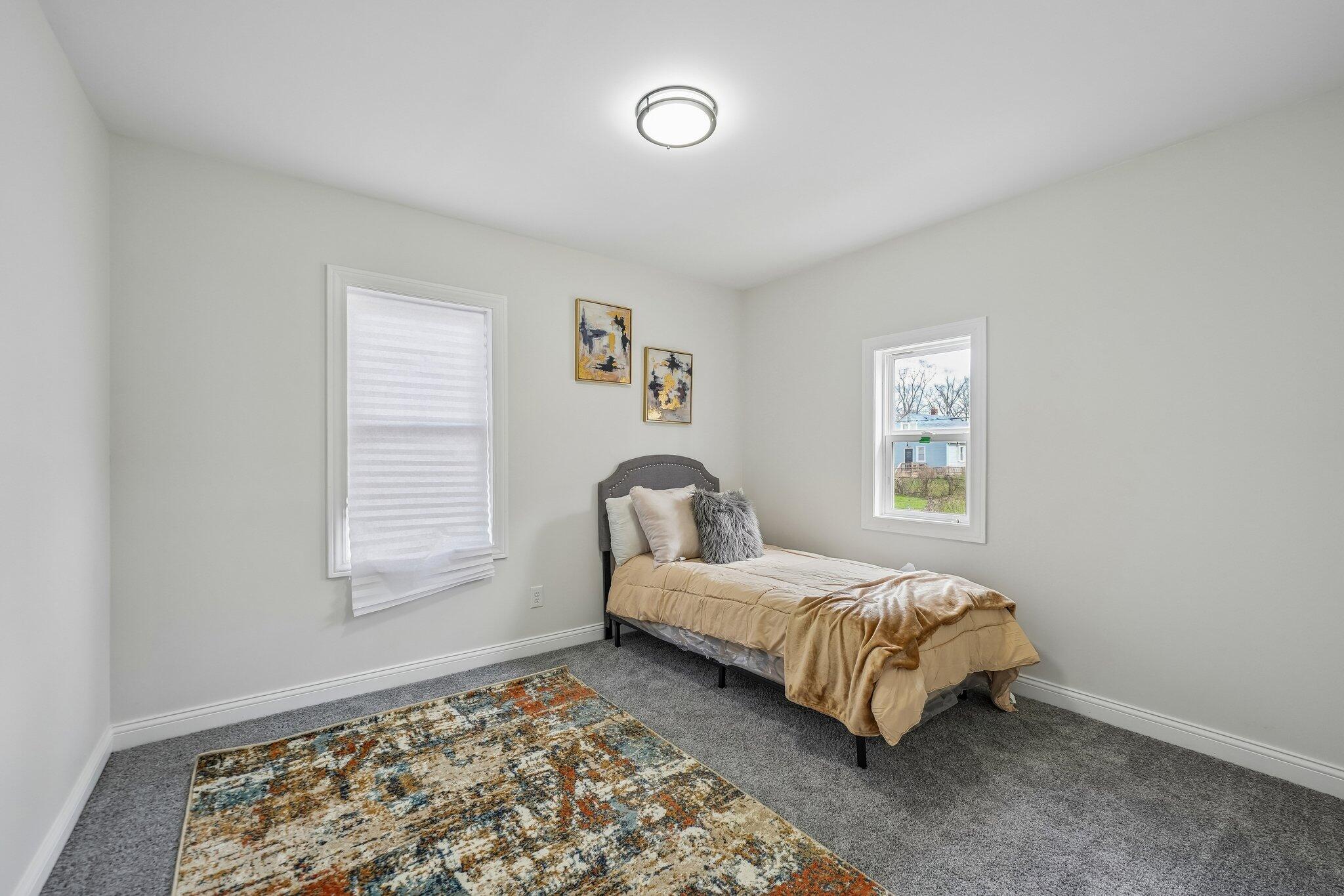 1043 Colfax Street Gary, IN 46406 - Photo 11 of 15 a bedroom with a bed and a window