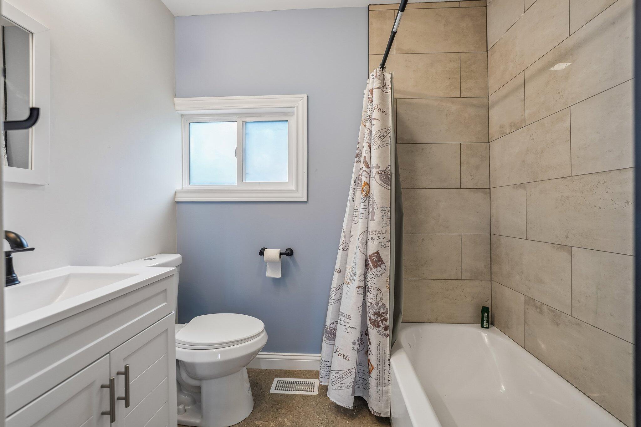 1043 Colfax Street Gary, IN 46406 - Photo 12 of 15 a bathroom with a sink a toilet and shower