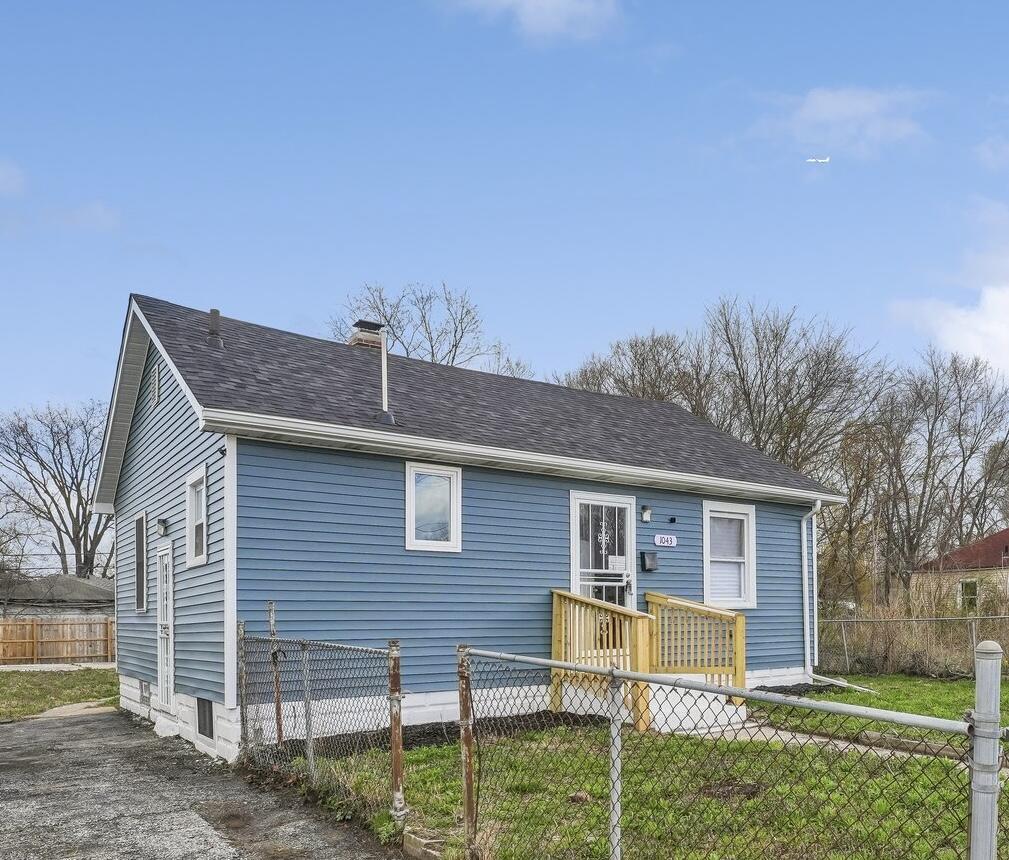 1043 Colfax Street Gary, IN 46406 - Photo 2 of 15 a view of a house with a yard