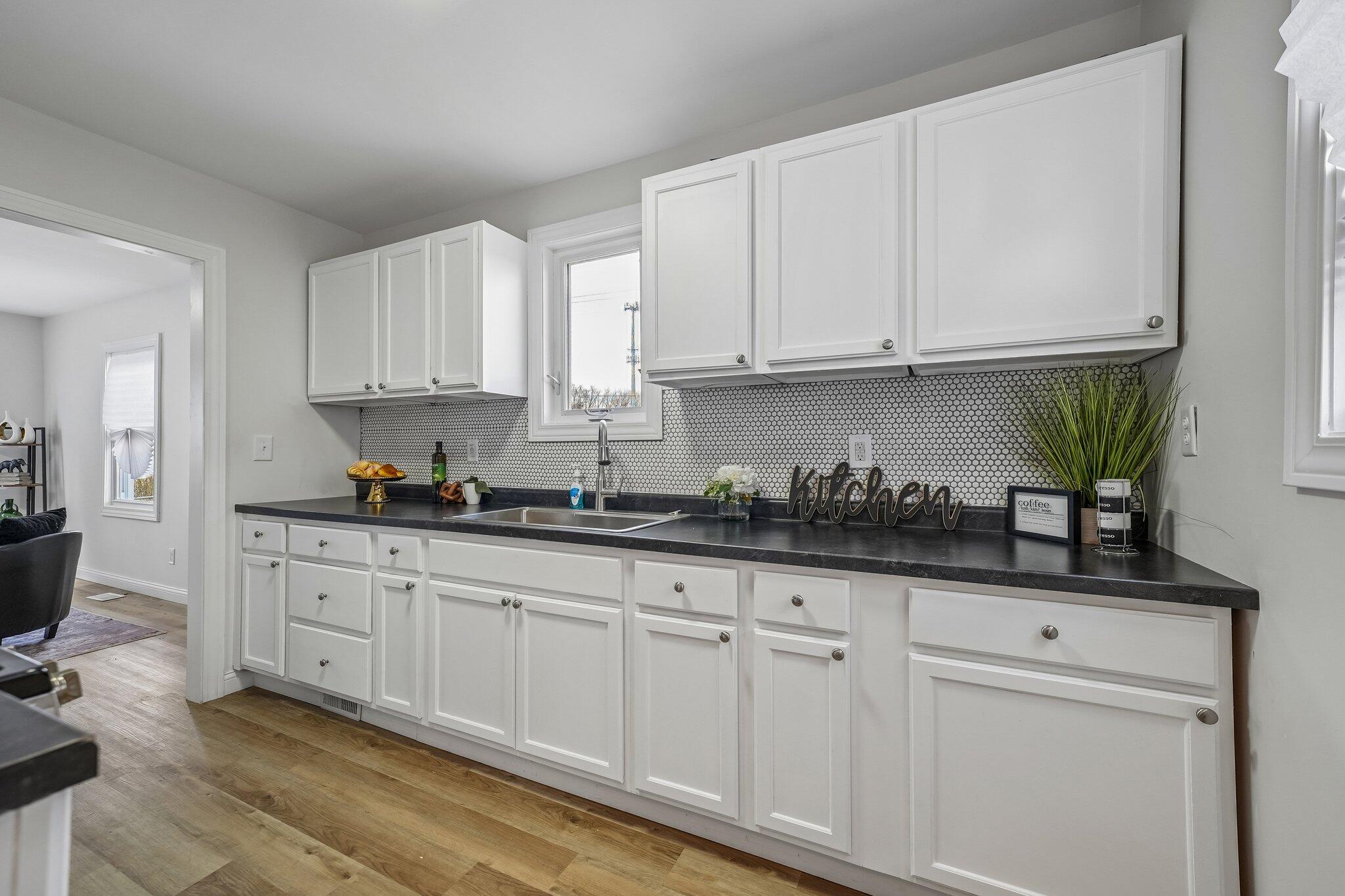1043 Colfax Street Gary, IN 46406 - Photo 6 of 15 a kitchen with granite countertop white cabinets and white appliances