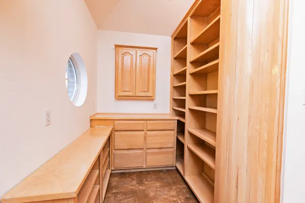 a view of walk in closet with empty racks