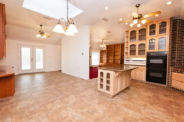 a kitchen with stainless steel appliances a stove top oven and cabinets