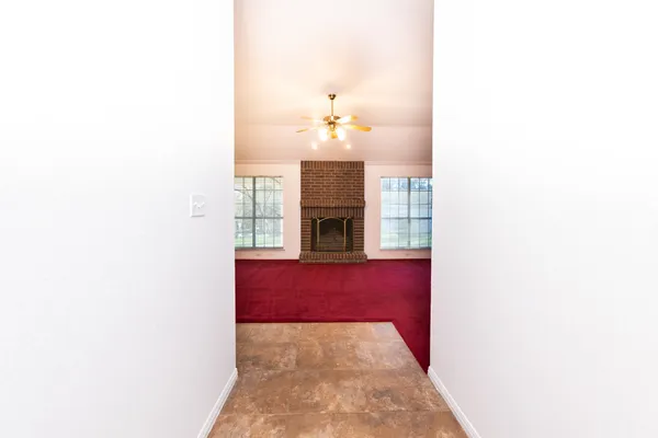 a view of an empty room with a fireplace