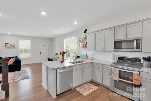 a kitchen with a sink appliances and cabinets