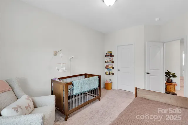 a bedroom with furniture and a book shelf