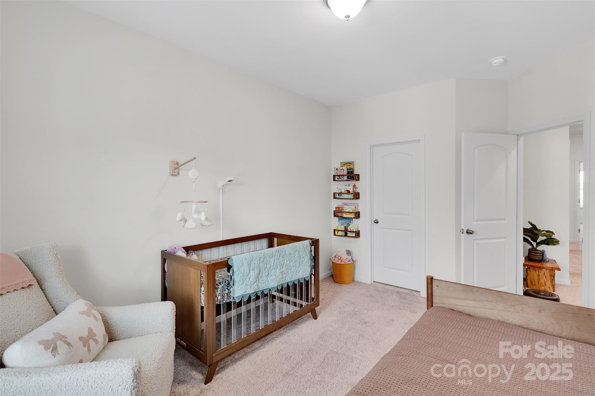2131 Stevens Mill Road Matthews, NC 28104 - Photo 18 of 27 a bedroom with furniture and a book shelf