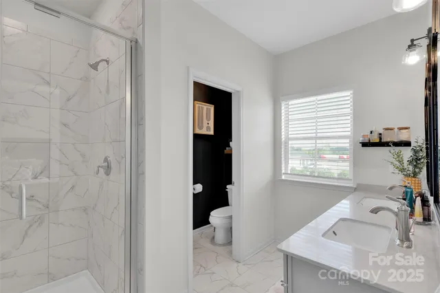 a bathroom with a glass shower door