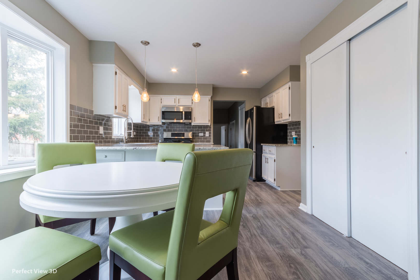 1100 West Seil Road Shorewood, IL 60404 - Photo 11 of 30 a kitchen with a table chairs refrigerator and cabinets