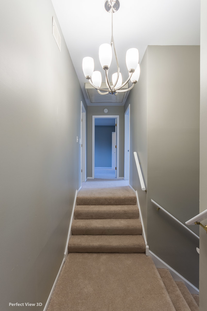 1100 West Seil Road Shorewood, IL 60404 - Photo 21 of 30 a view of a balcony with a chandelier