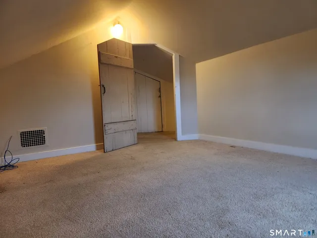 a view of an empty room with a fireplace