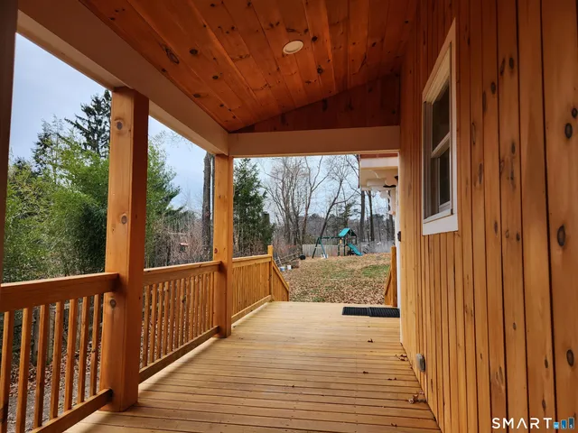 a view of a porch with wooden floor and outdoor space