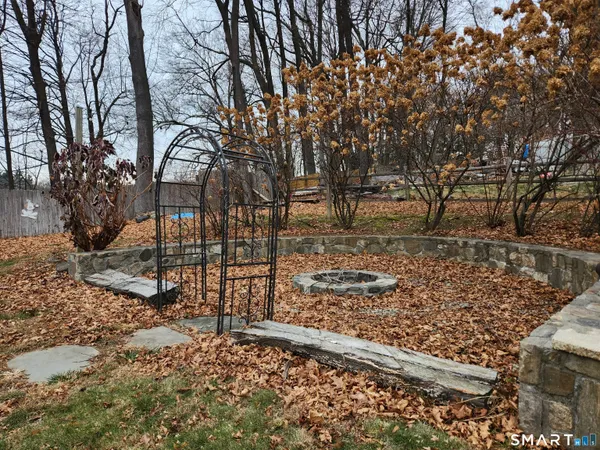 a view of a yard with wooden fence