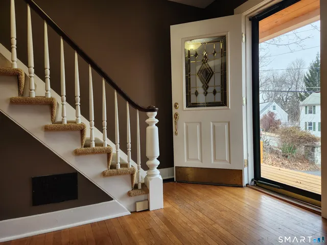 a view of an entryway with wooden floor and door