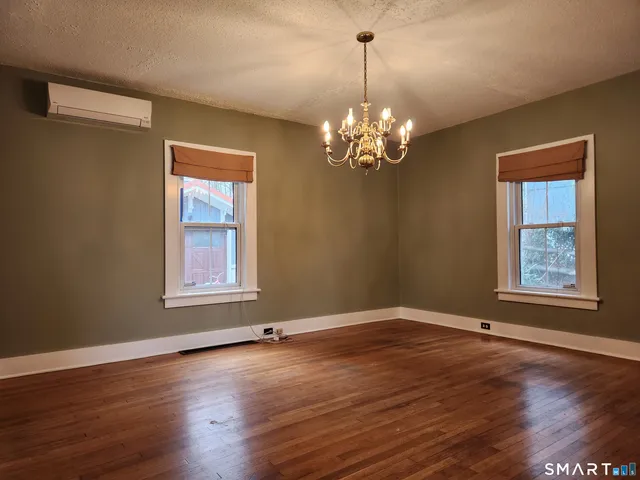 a view of livingroom with window wooden floor and chandelier