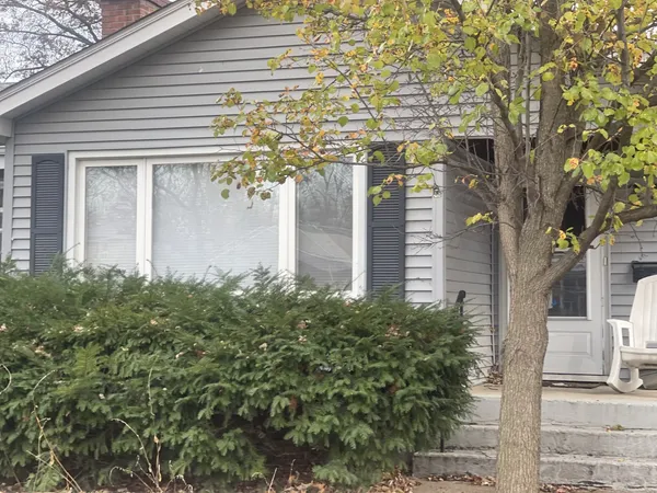 a yellow house with trees in front of it
