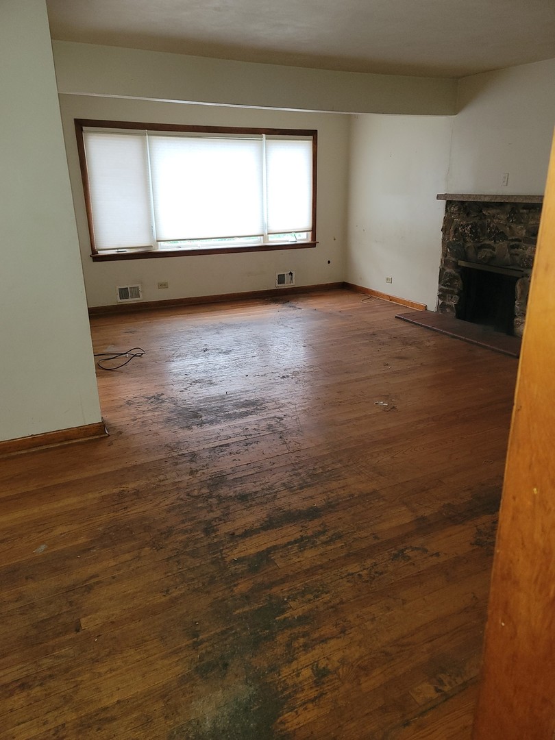 213 South Summit Street Wheaton, IL 60187 - Photo 11 of 33 a view of an empty room with a window and wooden floor