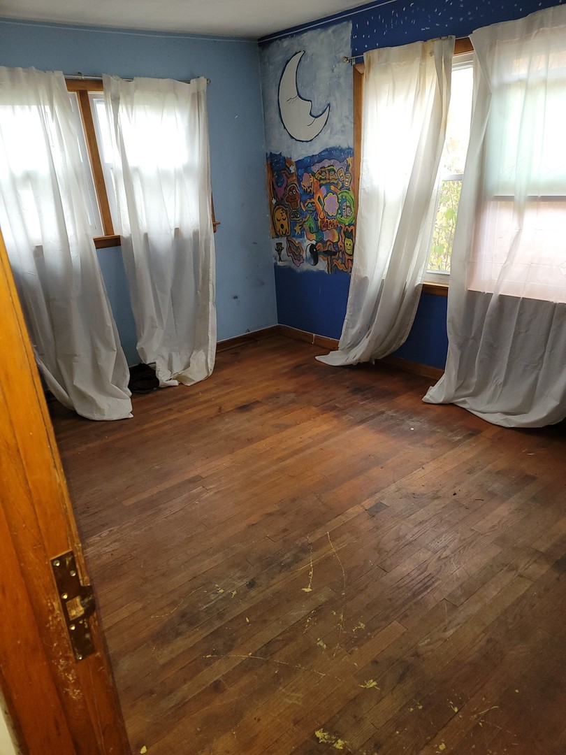 213 South Summit Street Wheaton, IL 60187 - Photo 15 of 33 a view of an empty room with a window and wooden floor
