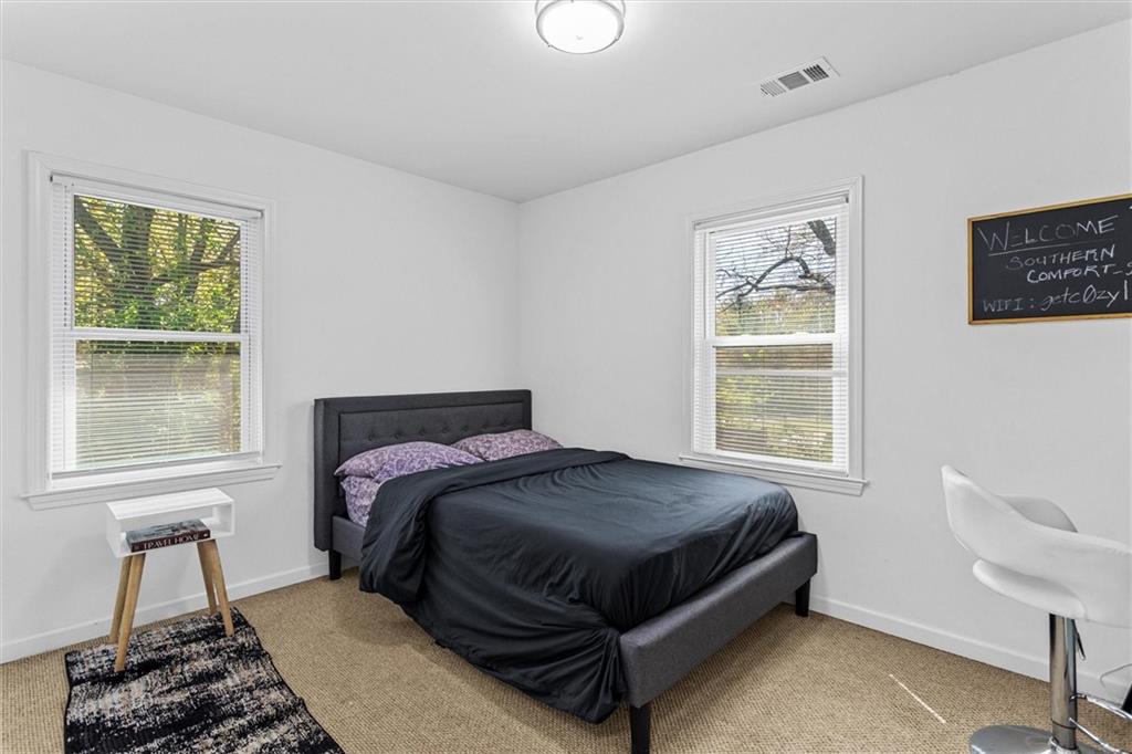 1111 Valley View Road Southeast Atlanta, GA 30315 - Photo 14 of 31 a bed sitting in a bedroom next to a window