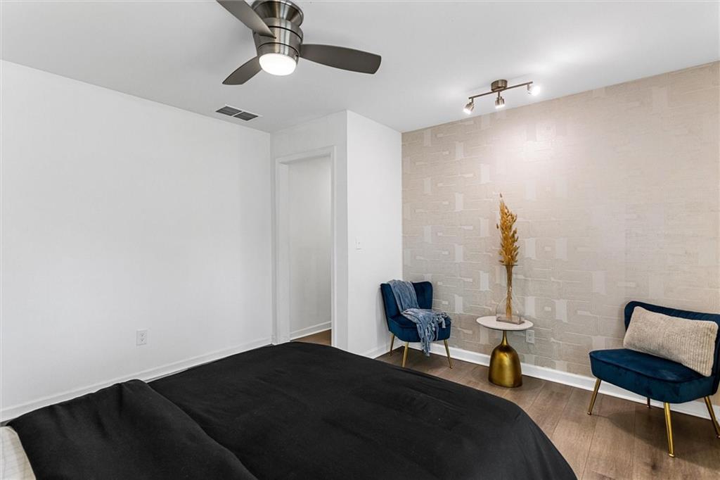 1111 Valley View Road Southeast Atlanta, GA 30315 - Photo 22 of 31 a bedroom with bed and a chair