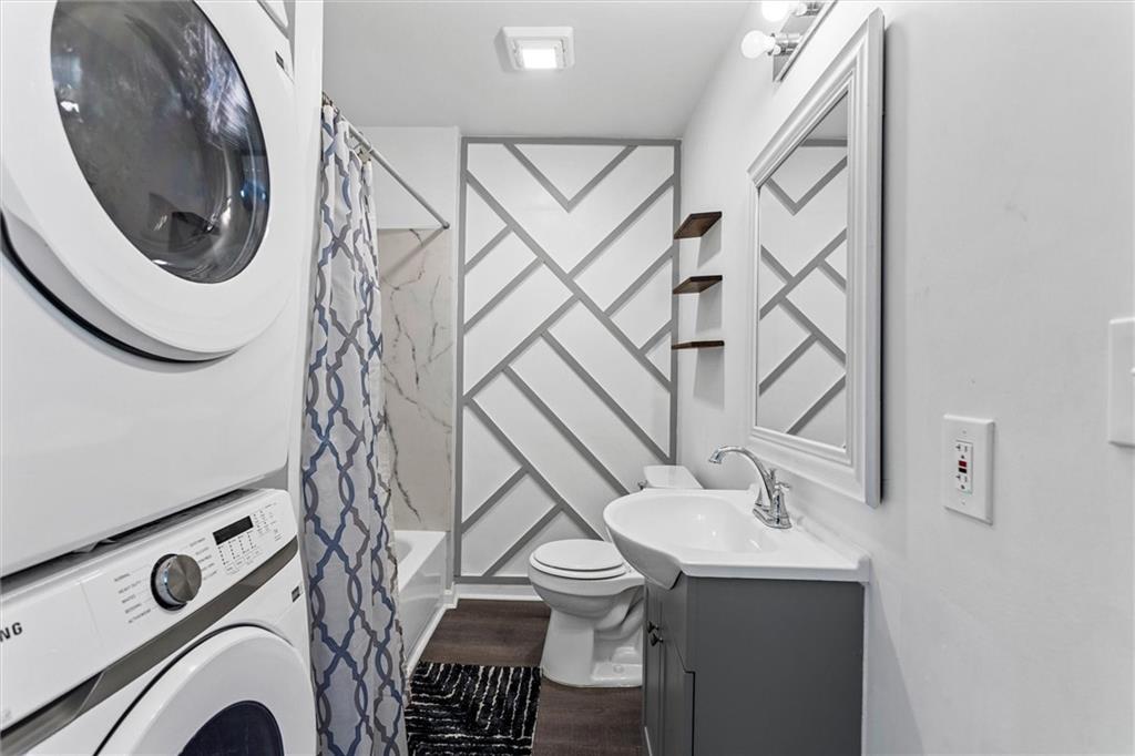 1111 Valley View Road Southeast Atlanta, GA 30315 - Photo 3 of 31 a bathroom with a sink mirror and toilet