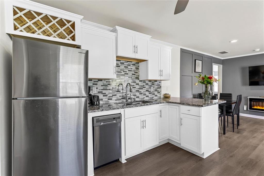 1111 Valley View Road Southeast Atlanta, GA 30315 - Photo 10 of 31 a kitchen with stainless steel appliances a refrigerator sink and cabinets