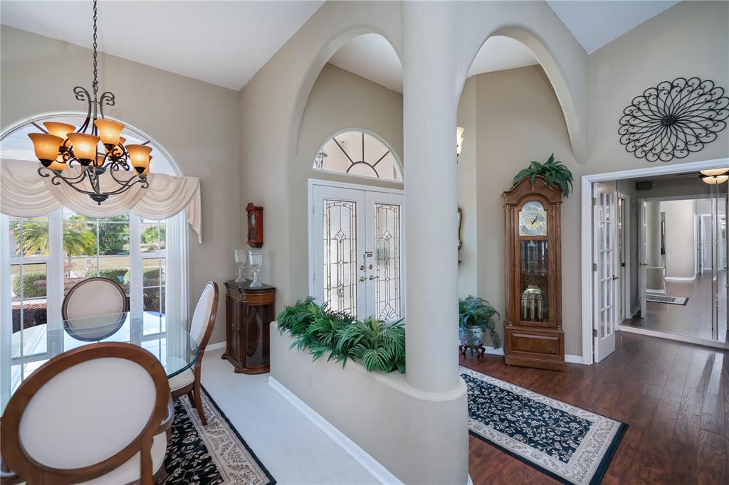 26373 Madagascar Road Punta Gorda, FL 33983 - Photo 11 of 90 a view of a hallway with wooden floor and a chandelier