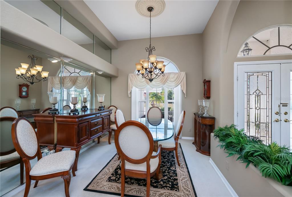 26373 Madagascar Road Punta Gorda, FL 33983 - Photo 18 of 90 a dining room with furniture a chandelier and wooden floor