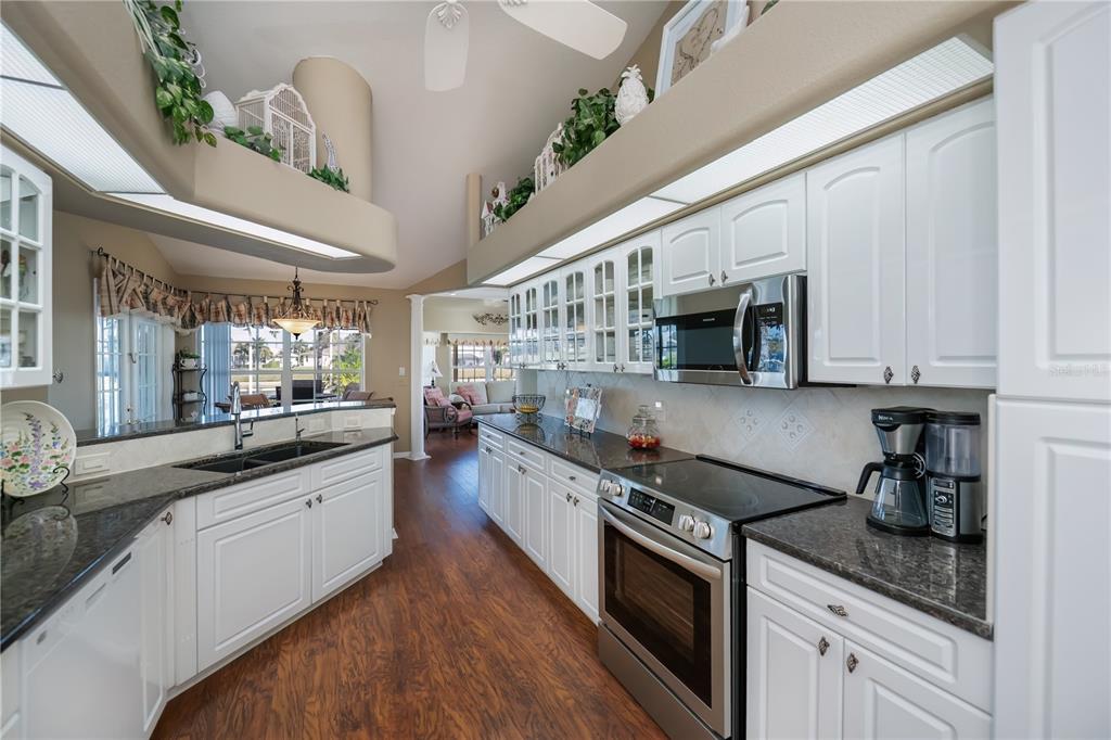 26373 Madagascar Road Punta Gorda, FL 33983 - Photo 24 of 90 a kitchen with stainless steel appliances granite countertop a sink a stove and cabinets