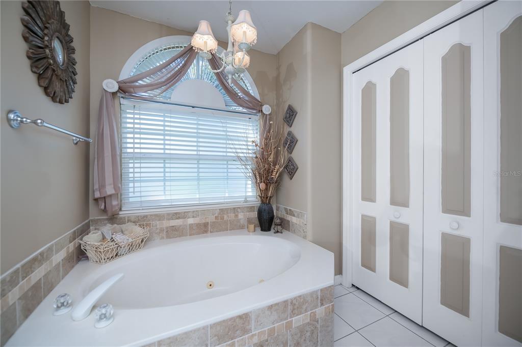 26373 Madagascar Road Punta Gorda, FL 33983 - Photo 40 of 90 a white bath tub sitting in a bathroom next to a window
