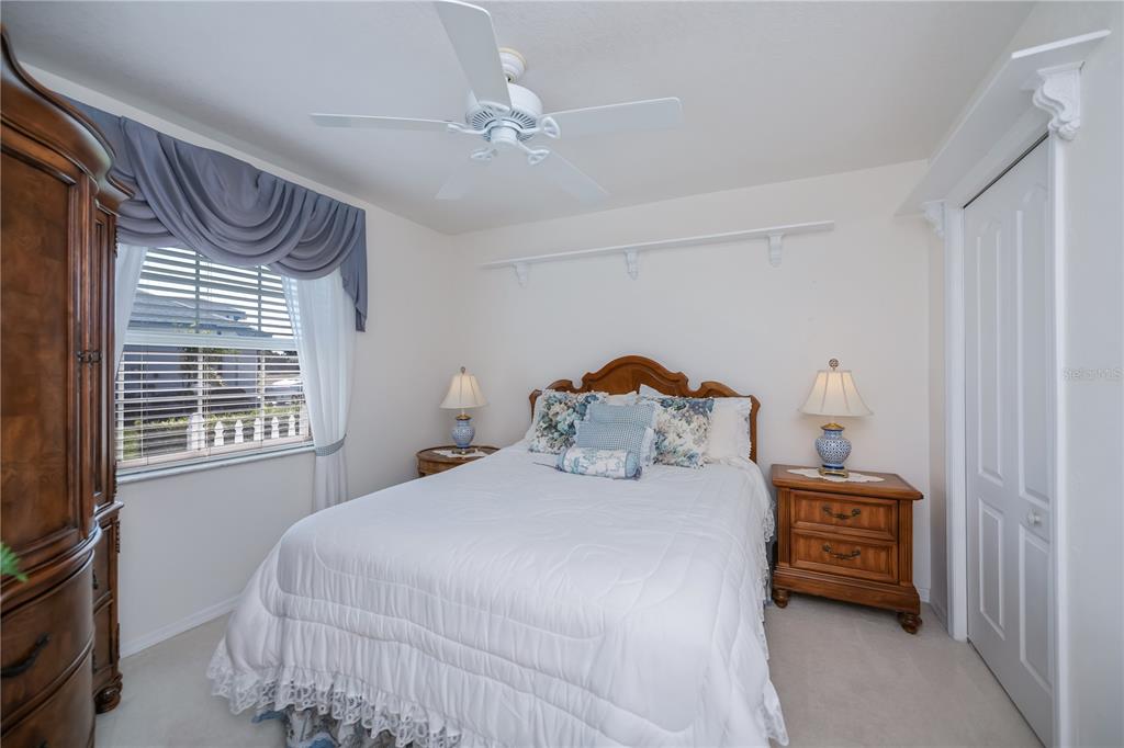 26373 Madagascar Road Punta Gorda, FL 33983 - Photo 48 of 90 a bedroom with a bed and a chandelier