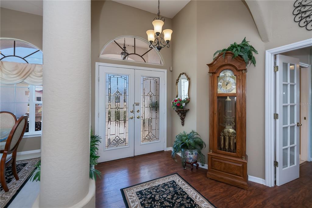 26373 Madagascar Road Punta Gorda, FL 33983 - Photo 10 of 90 a view of a hallway with wooden floor and a chandelier