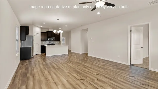 a view of kitchen with refrigerator microwave and stove